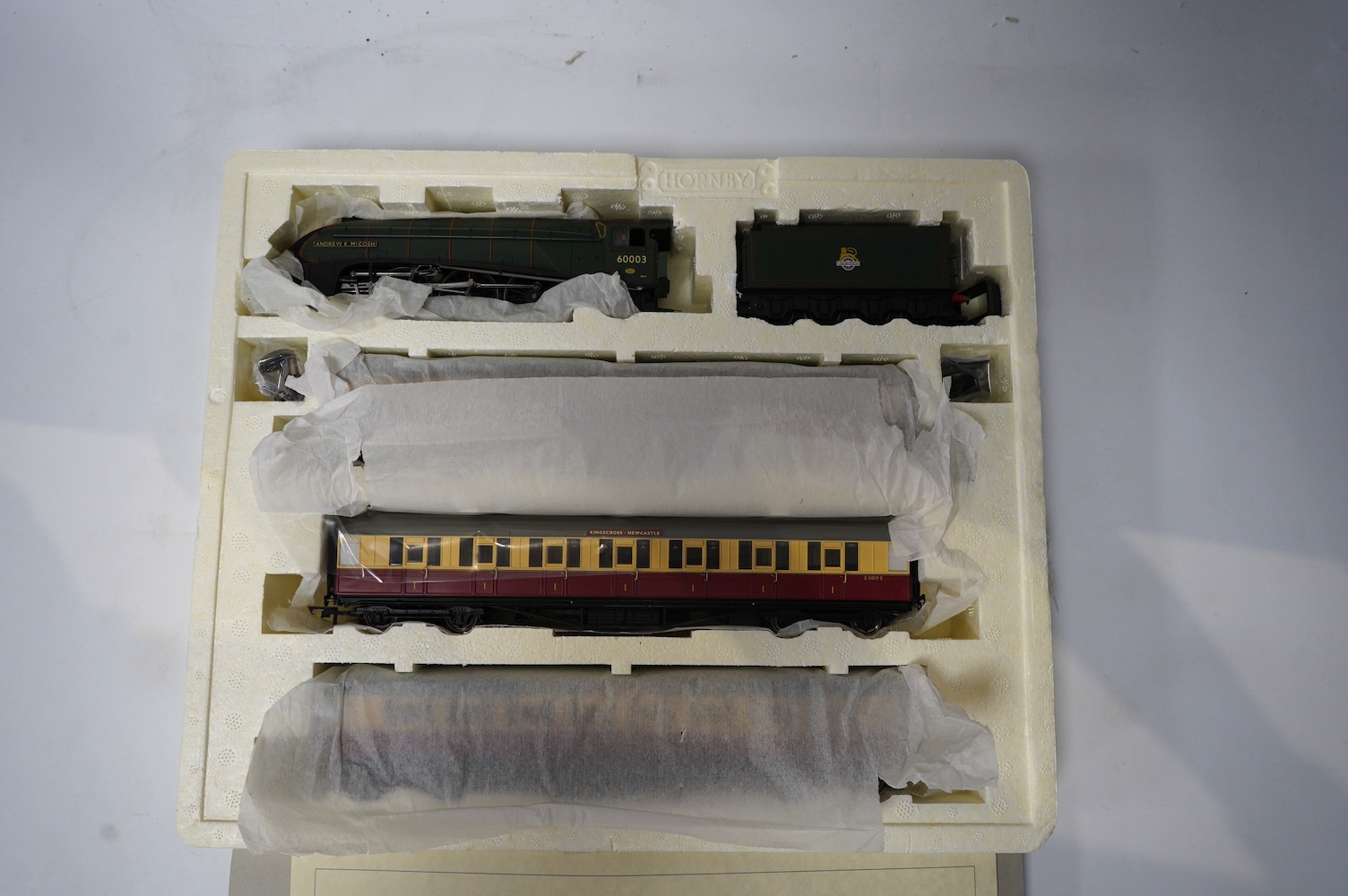 A Hornby Hobbies 00 gauge railway ‘the Northumbrian’ train pack, R2435, together with ‘the Northumbrian Coaches’ coach pack, R4228, comprising of a BR Class A4 locomotive and six maroon and cream coaches. Condition - goo